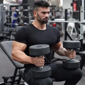 Men's black slim-fit cotton gym T-shirt shown on a model in a professional fitness setting