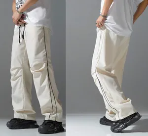 Detailed side view of men's high street paratrooper cargo pants with black side stripes