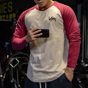 Close-up of a men's raglan long-sleeve fitness T-shirt in two-tone red and off-white