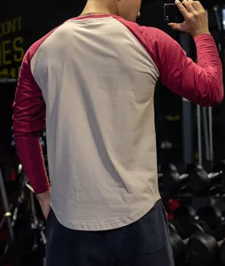 Back view of men's raglan long sleeve gym shirt featuring maroon color block sleeves