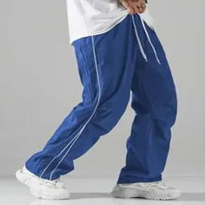 Blue paratrooper pants with white side stripes and quick-dry fabric detail.