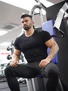Men's slim fit black cotton workout T-shirt, muscle fit breathable tee in gym setting