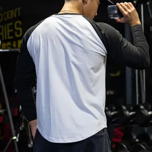 Detail view of men's athletic raglan long-sleeve T-shirt in black and white color-block