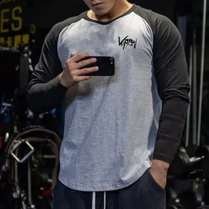 Detailed view of a slim fit men's raglan long sleeve gym T-shirt in grey and black