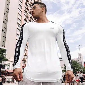 Detail view of a white men's fitness long sleeve shirt with motivational sleeve text
