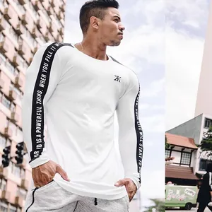 White men's quick-dry athletic long sleeve compression shirt with text on sleeves