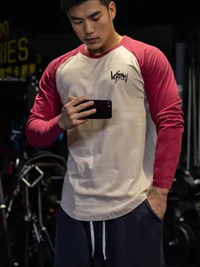 Men's athletic raglan long sleeve T-shirt in a breathable color block style for gym
