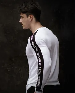 Detailed side view of white men's compression shirt showing black slogan sleeve