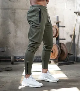 Detail view of olive green fitness cargo joggers for men with side zipper pockets