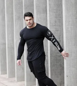 Athletic men's black compression long-sleeve top featuring graphic printed sleeves