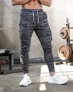 Detailed view of men's slim fit camouflage joggers with side pockets in gym setting