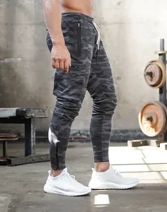 Detailed side view of men's gray camouflage cargo joggers with pockets in gym setting