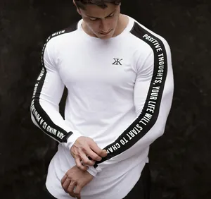 Close-up of white men's compression long-sleeve training shirt with sleeve text details