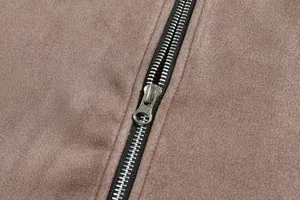 Detailed macro view of high-quality metal zipper on brown suede casual jacket for men