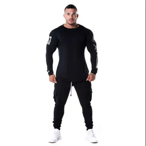 Full body front view of a muscular man wearing a black long-sleeve fitness compression shirt