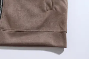 Detailed close-up of the bottom hem and pocket stitching on a brown casual jacket