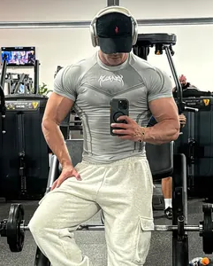 Detailed view of men's grey high-elastic compression gym t-shirt highlighting muscular fit