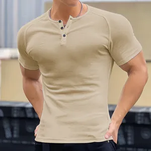 Close-up view of khaki men's ribbed muscle fit T-shirt with Henley collar buttons.
