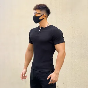 Slim fit muscle-fit black ribbed short sleeve Henley t-shirt for men on an athletic model
