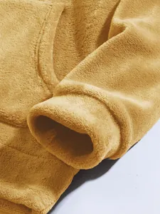 Close-up detail of a yellow coral fleece hoodie sleeve showing soft plush texture and stitching