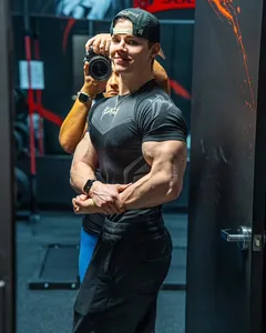 Men's high elastic compression muscle fit gym t-shirt shown on a muscular model in a gym