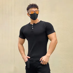 Detail shot of men's muscle fit black ribbed short sleeve Henley t-shirt
