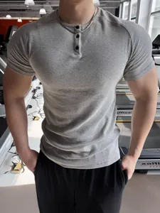 Premium men's slim fit ribbed grey Henley t-shirt highlighting athletic muscle build