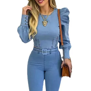 Detail view of a chic light blue denim cropped shirt featuring puff sleeves and button cuffs.