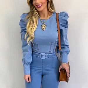 Detail of a slim fit light blue denim cropped shirt with stylish puff sleeves.