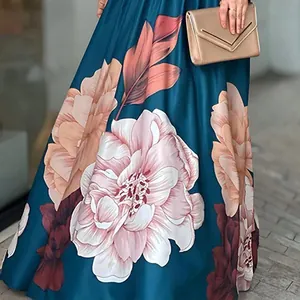 Detailed close-up of vibrant large floral print on a teal maxi skirt fabric texture.