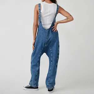 Back view of vintage-inspired blue denim overalls with adjustable straps on a model.