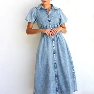 Close-up showing the puff sleeves and button-down front of a light wash denim maxi dress