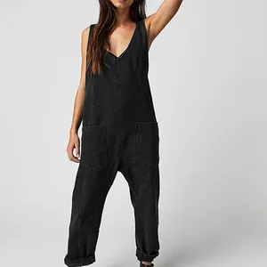 Front view of a loose black V-neck denim jumpsuit with large functional pockets