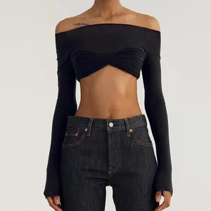 Detailed view of a black off-the-shoulder long sleeve crop top featuring a ruched bust design