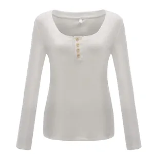 Front detail of women's white slim-fit U-neck long-sleeve T-shirt with wood buttons
