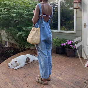 Relaxed fit blue denim overalls for women featuring adjustable straps and functional pockets
