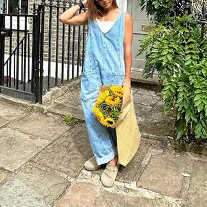Woman wearing stylish light blue denim V-neck overalls with large front pockets.