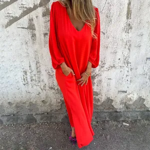 Detail of a bright red loose V-neck maxi dress with long lantern sleeves for spring