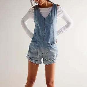 Close-up front view of light wash denim overalls featuring large pockets and rolled cuffs