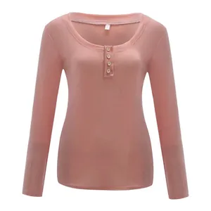 Close-up detail of women's pink long-sleeve slim-fit t-shirt with button U-neck