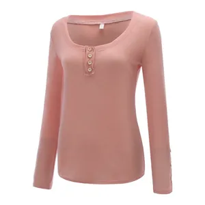 Elegant women's slim fit pink long sleeve T-shirt with U-neck and front button detailing.