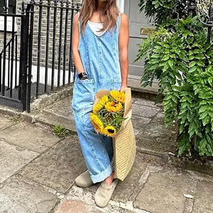 Detail of light blue denim jumpsuit with V-neck and pockets in a street setting