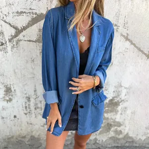 Close-up detail of women's loose denim blazer featuring notch lapels and pockets.