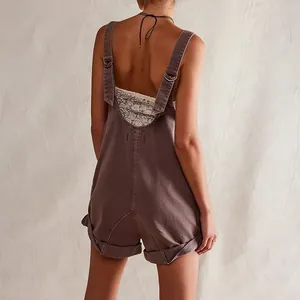 Back view of brown washed denim overalls with adjustable straps and rolled hem detail