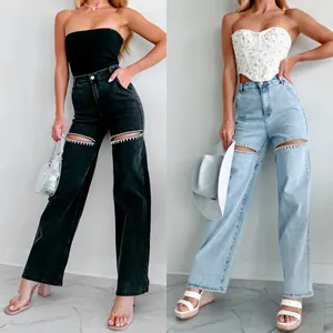 Women's high waist wide leg jeans featuring rhinestone trim cut-outs in black and light blue
