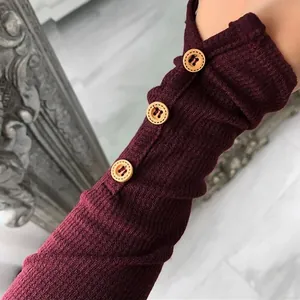 Detailed view of the burgundy ribbed long sleeve featuring elegant decorative wooden buttons