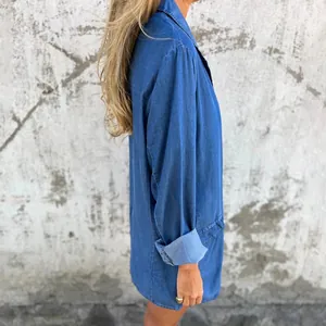 Side view of a loose blue long-sleeved denim jacket for women with rolled-up cuffs
