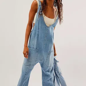 Detail of light blue denim overalls featuring a V-neck and large utility side pockets