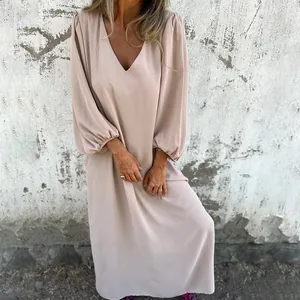 Detail view of a loose V-neck maxi dress with elegant lantern sleeves in light beige