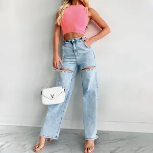 Stylish light blue straight jeans with rhinestone-embellished cutouts and distressed finish.